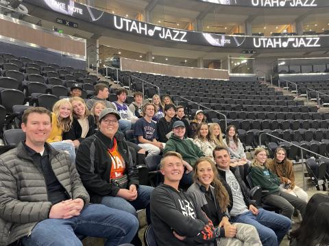 DECA students sitting lower bowl to watch the players warm-up. 