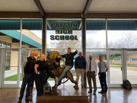 Kevin poses on our Lion statue with PHS administration