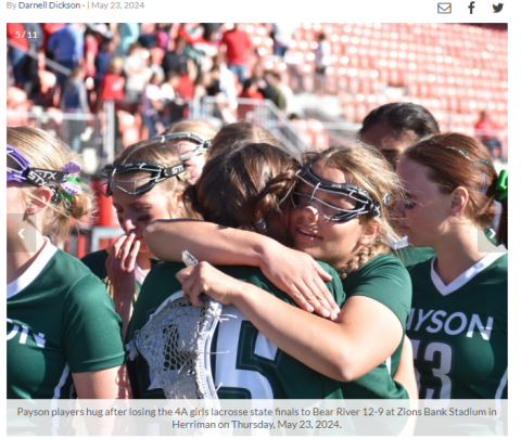 girls lacrosse team members hug