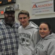 Senior wrestler posing with parents