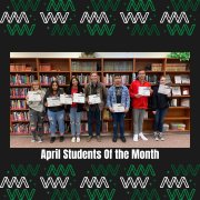 Students of the month pose with their certificates